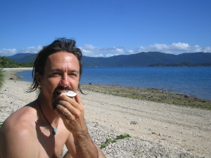 Eating fresh coconut at Sandy Bay